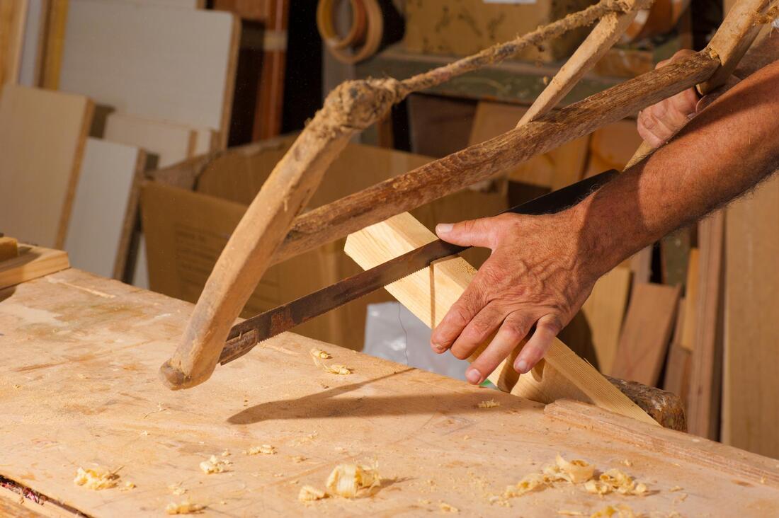 man sawing a wood